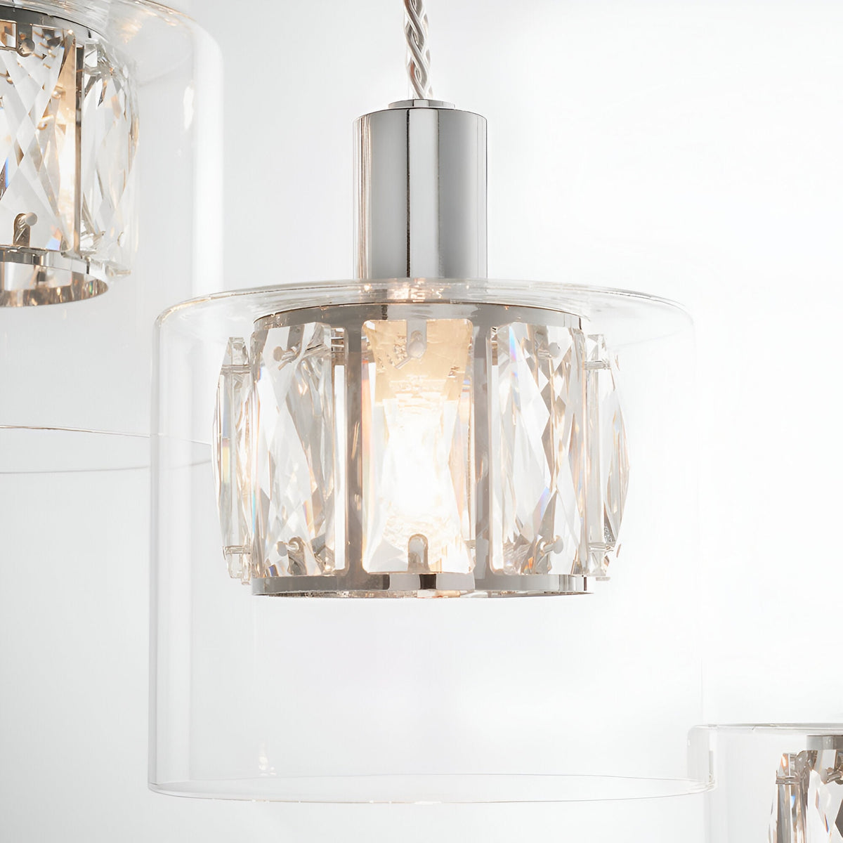 Marguerite 12 Light Pendant in polished chrome, close-up of one crystal-clad drum shade within a clear glass diffuser on twisted cable.