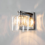Endon Marguerite chrome wall light with faceted crystal shade inside a clear glass diffuser, illuminated against a plain pale wall.