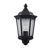 Matt black die-cast aluminium Ashshaw Coach Lantern with clear glass panels, decorative top detailing and visible E27 bulb.