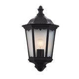 Ashshaw Coach Lantern in matt black die-cast aluminium with clear glass panels, flush wall-mounted design and lit E27 bulb, shown on a plain white background.