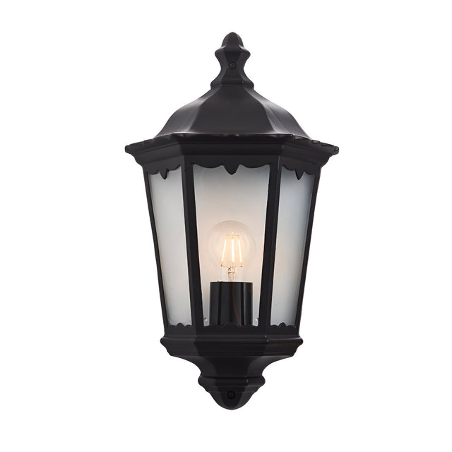 Ashshaw Coach Lantern in matt black die-cast aluminium with clear glass panels, flush wall-mounted design and lit E27 bulb, shown on a plain white background.