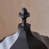 Close-up of the finial on Endon Ashshaw Bollard Light in matt black die cast aluminium, showing the pointed cap and hexagonal base detail.