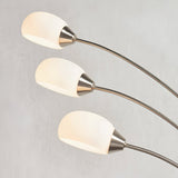 Endon Brockcombe 3 light floor lamp with satin nickel arched arms and white glass shades, shown in close-up against a light grey background.