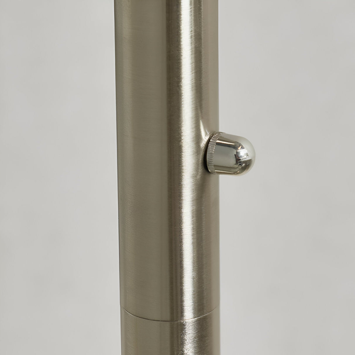 Close-up of the Brockcombe 5 Light Floor Lamp's satin nickel pole with a knurled rotary dimmer knob, shown against a plain light background.