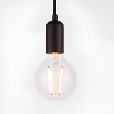 Endon Marlowe pendant light with a matt black E27 lamp holder on black fabric flex, fitted with a clear globe filament LED bulb, on white.