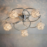 Endon Seraphine 5 light semi-flush ceiling light with polished chrome rings and crystal globe shades, shown lit against a pale wall.