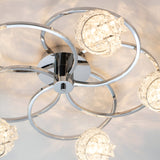 Endon Seraphine 5 light semi-flush ceiling light in polished chrome, with looped ring arms and crystal glass shades, viewed close-up from below.