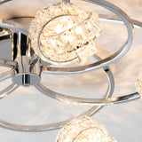 Close-up of Endon Seraphine 5 light semi-flush ceiling light showing polished chrome rings and faceted crystal shades around illuminated G9 lamps.