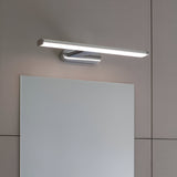 Carlshaw LED bathroom wall light in chrome with a frosted opal diffuser, mounted above a mirror on a light grey wall, illuminated.