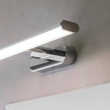Carlshaw LED bathroom wall light in chrome with a slim linear opal diffuser, mounted above a mirror and casting bright daylight-toned light.