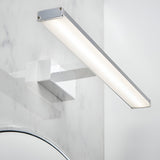 Endon Aldshaw LED bathroom wall light in chrome with a slim frosted diffuser bar, mounted on a marble wall above a chrome tap and mirror.