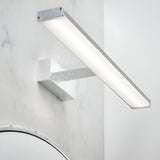 Endon Aldshaw LED bathroom wall light in chrome with a slim frosted diffuser bar on a square bracket, mounted on a marble wall above a mirror.