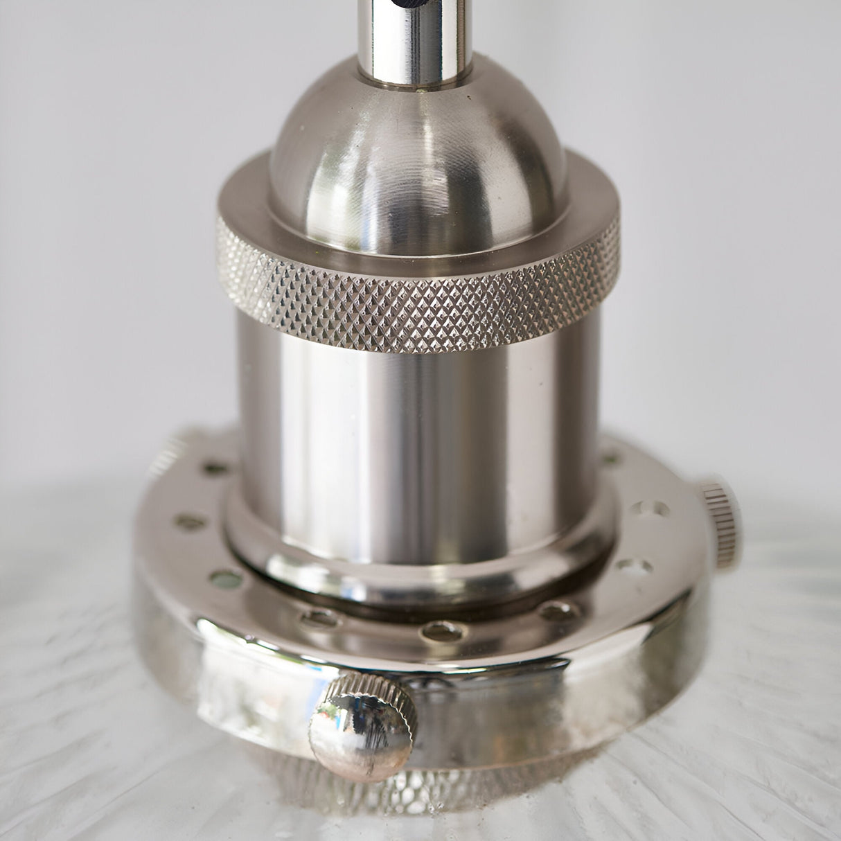 Close-up of the Wentworth Pendant Light in nickel, showing the knurled lamp holder, dome top, and metal rim on ribbed glass shade.