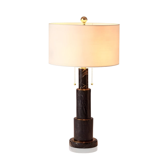 The Eloria 1 Light Stacked Alabaster Table Lamp in Soft White & Black features a white cylindrical shade, black marble base, gold accents, and two pull chains, beautifully illuminated against a white background.