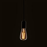 Endon 2W E27 LED filament pear bulb with clear glass and warm white glow, suspended from a black pendant cord holder against a dark background.
