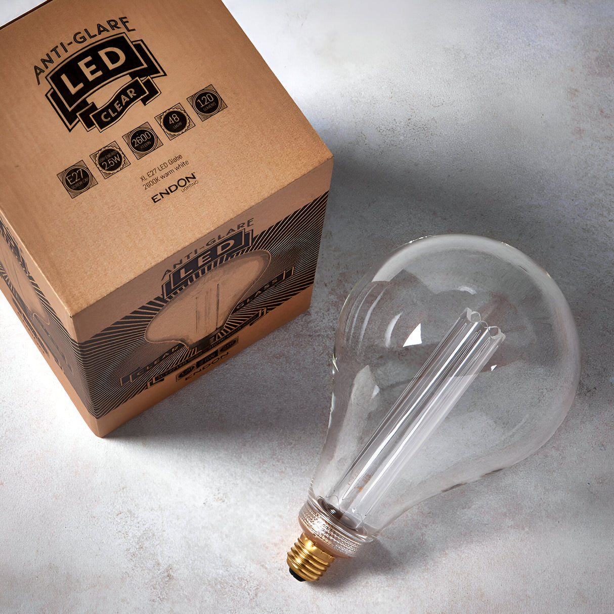 Oversized clear E27 LED globe bulb with visible filament sleeve, shown beside its Anti-Glare LED packaging on a light background.