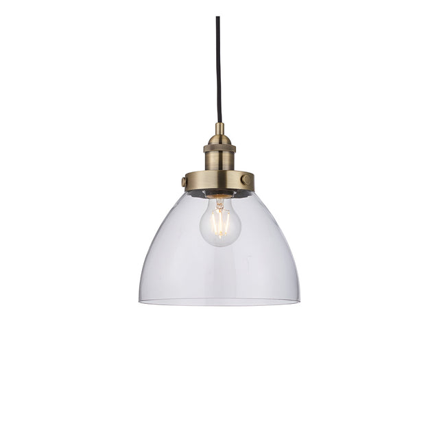 Endon Wentworth small industrial pendant light with clear glass dome shade, knurled antique brass lamp holder and black flex, on a white background.