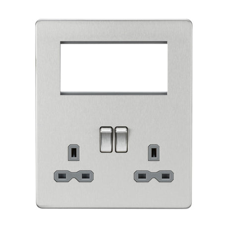 The Small Multimedia Combination Plate in brushed chrome with a black insert, designed to be screwless, features two power sockets and two switches. It includes an empty rectangular slot at the top for bespoke signal distribution or modular inserts, facilitating seamless future enhancements.