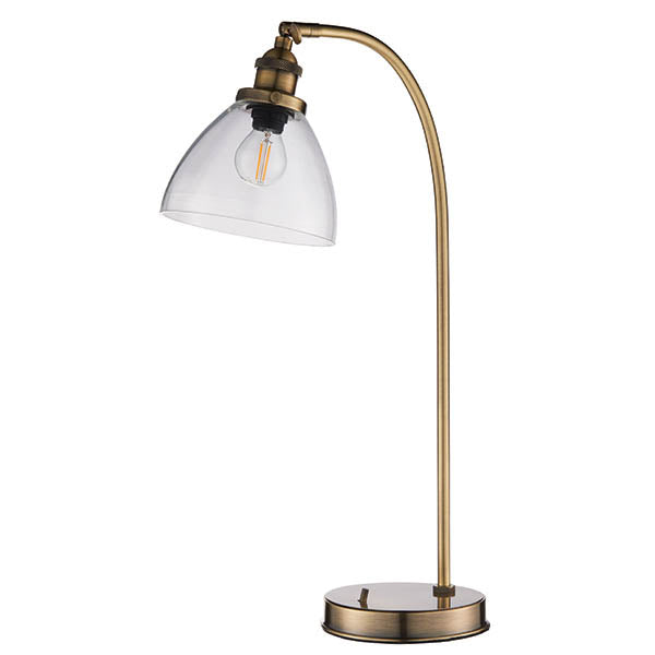 Wentworth Table Lamp in brass with curved metal base, adjustable knuckle joint, clear glass dome shade and exposed E14 bulb, shown on a white background.