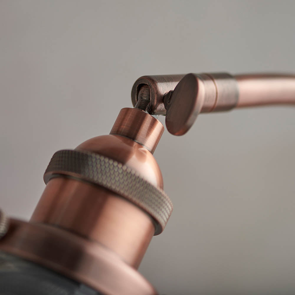 Close-up of the Endon Wentworth Table Lamp in copper, showing the adjustable knuckle joint and knurled lamp holder against a light grey background.