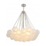 The Orb 37 Light Cluster Suspension - Silver features multiple frosted glass spheres grouped together, hanging from a central silver fixture. The globes emit a soft, warm glow, adding a modern touch to any space.