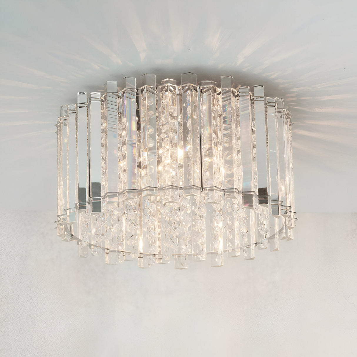 Brenbourne Flush Ceiling Light in chrome, tiered clear crystal and faceted glass droplets, illuminated against a plain white ceiling.
