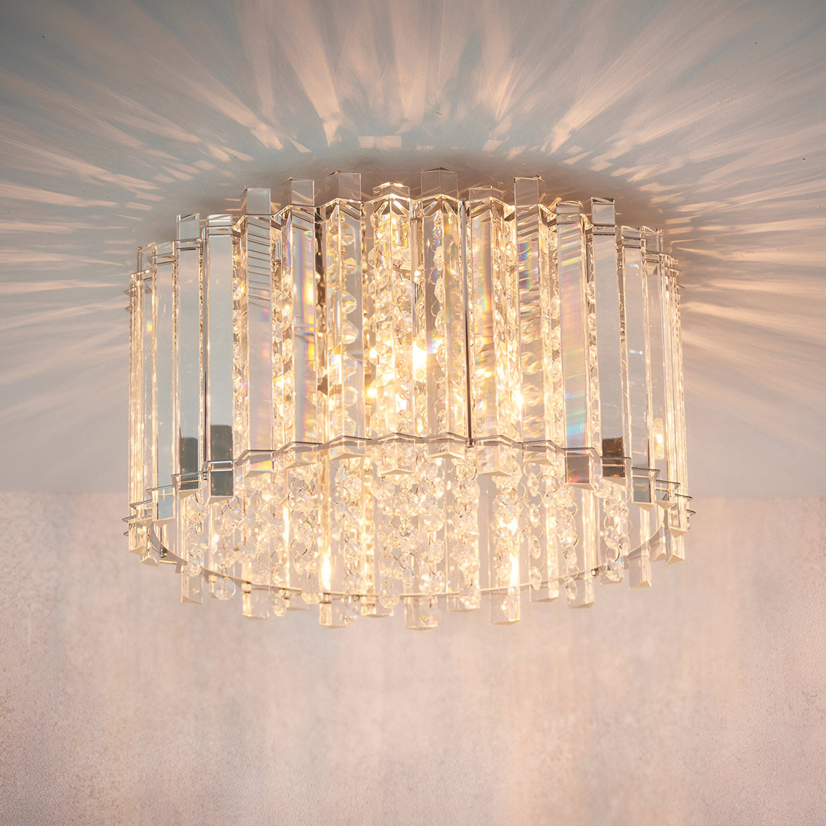 Brenbourne Flush Ceiling Light in chrome, with tiered rows of clear crystal glass rods creating a starburst light effect on the ceiling above.