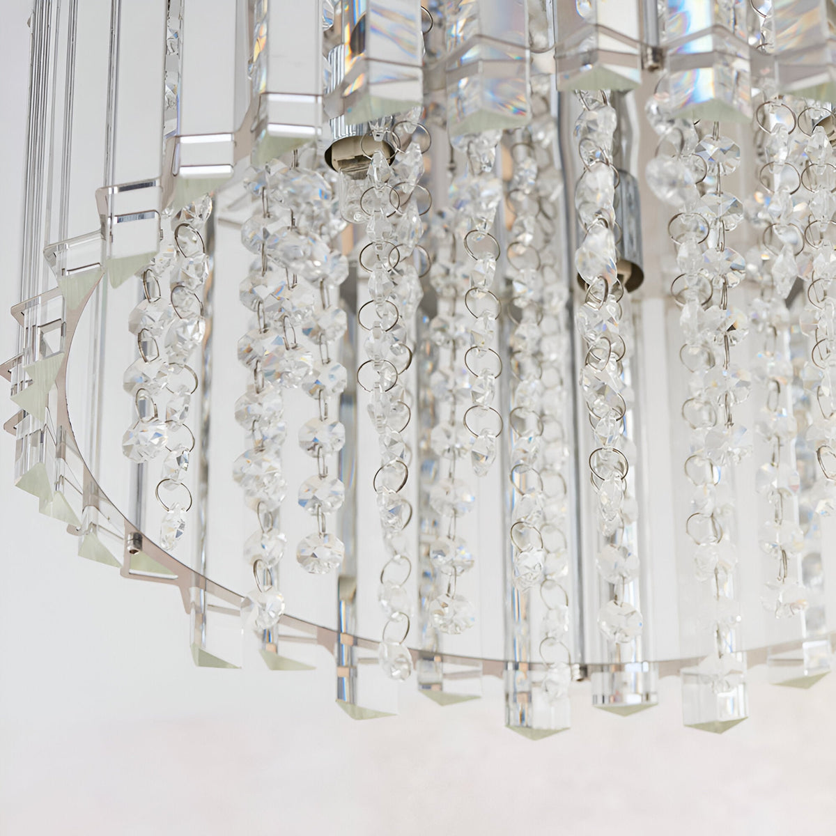 Close-up of the Brenbourne flush ceiling light showing tiered clear crystal droplets on a polished chrome frame, against a plain white background.