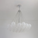 The Orb 37 Light Cluster Suspension - Silver features frosted glass spheres in a grid, suspended by sleek metal cables from a central chrome fixture for a modern, elegant ceiling statement.