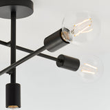 Close-up of the Endon Marlowe 5 Light Semi-Flush Ceiling Light in black, showing metal arms with E27 lamp holders and clear filament bulbs.