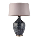 Endon Brenwick table lamp with black speckled glass body, matt nickel base and mink faux silk tapered drum shade on a white background.