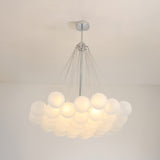The Orb 37 Light Cluster Suspension - Silver features multiple frosted glass spheres elegantly clustered from a central silver fixture, creating a striking statement on any white ceiling.