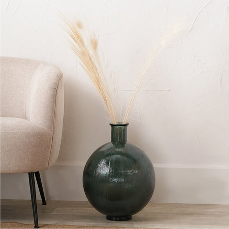 Sea Green Recycled Glass Vase, 34cm, round textured body with narrow neck, holding dried pampas grass beside a beige armchair in a living room.