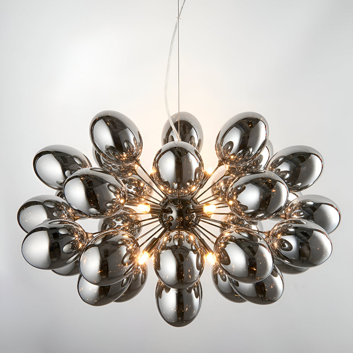 Endon Brenworth 8 light pendant with cluster of electro-plated dark chrome glass shades on a black chrome frame, suspended from clear flex.
