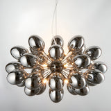 Endon Brenworth 8 light pendant with cluster of electro-plated dark chrome glass shades on a black chrome frame, suspended from clear flex.