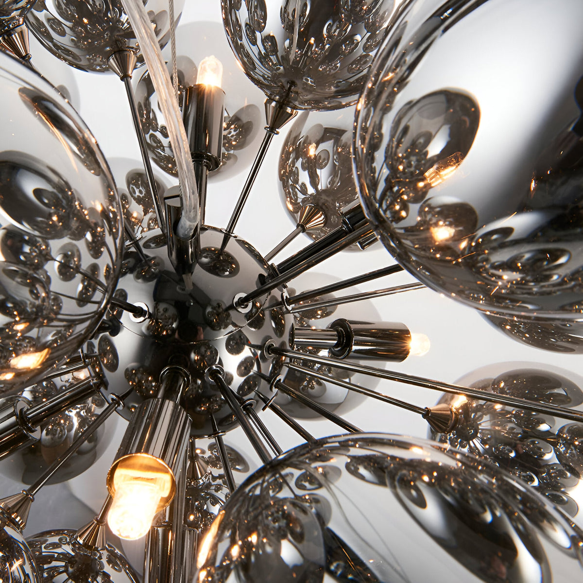 Close-up of Endon Brenworth 8 Light Pendant showing black chrome sputnik frame with electro-plated dark chrome glass shades and lit G9 lamps.