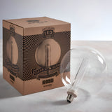 Endon 2.8W E27 LED clear globe bulb lying beside its printed kraft retail box on a light neutral surface.