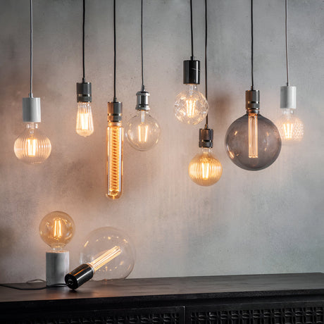 Endon 4W E27 LED filament bulbs displayed as a cluster of pendant lights in varied clear and smoked glass shapes against a grey concrete wall.