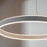 Bramford Pendant in nickel and white, a large circular ring fixture on thin cables with a glowing frosted edge, shown close-up against a soft grey background.