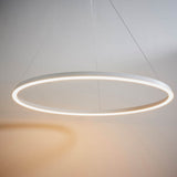 Endon Cliffton LED pendant in matt white, a slim large-diameter ring with illuminated diffuser suspended on fine cables against a pale wall.