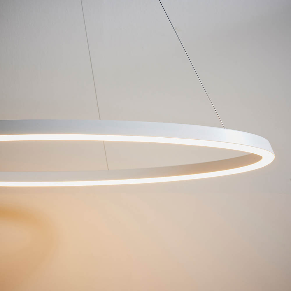 Endon Cliffton LED pendant in white, close view of the slim circular ring fitting suspended from fine wire cables with a lit diffuser edge.
