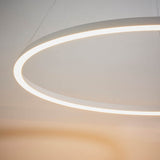 Endon Cliffton LED pendant in white, close-up of the slim illuminated ring with warm-glow diffuser, suspended by fine wires against a neutral wall.