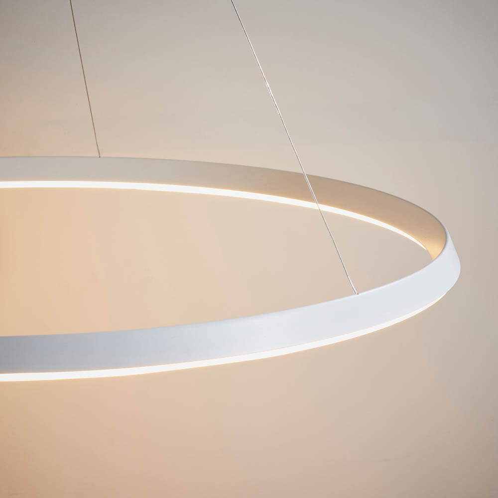 Close-up of the Endon Cliffton LED pendant in matt white, showing its slim circular profile and diffuser suspended on fine wire cables.
