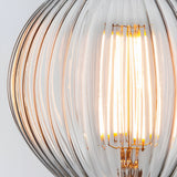 Close-up of a 4W E27 LED filament ribbed bulb with clear ridged glass and glowing warm white filaments, shown against a plain light grey background.