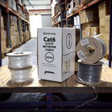 Mercury Cat6 U/UTP 305m network cable dispensing box beside grey and white cable reels on a warehouse pallet.