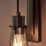 Endon Camden industrial wall light with braided cable, black chrome knurled fitting and tapered smoked glass shade over an exposed filament E27 bulb.