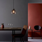 Camden Pendant Light in chrome, black and grey with smoked glass dome shade, single E27 bulb, shown above a dining table in a grey and terracotta room.