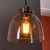 Camden Pendant Light in chrome and black with a smoked glass dome shade, exposed filament E27 bulb, and knurled metal fitting on black fabric flex.