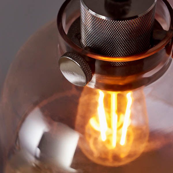 Camden Pendant Light in chrome and black, close-up of knurled metal lamp holder with glass shade and exposed E27 filament bulb.
