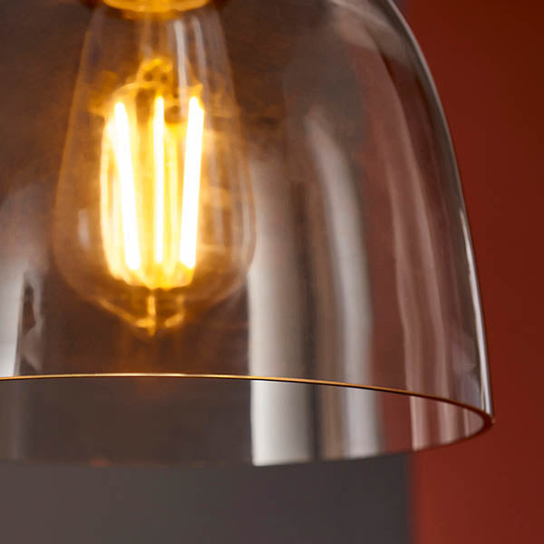 Camden Pendant Light in Chrome, Black & Grey, close-up of glass dome shade with visible E27 filament bulb and brass rim trim.